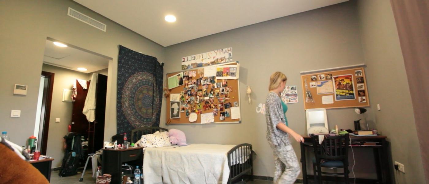 A student prepares for class in her modern dorm room within the U N E Tangier residences